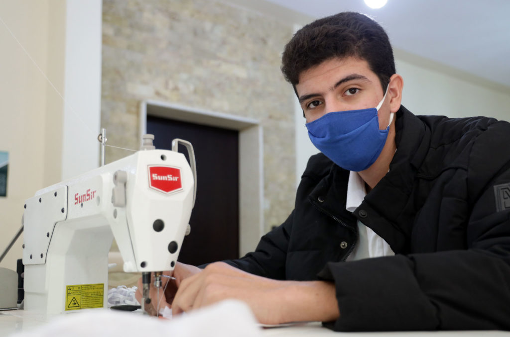 Hassan at his sewing machine