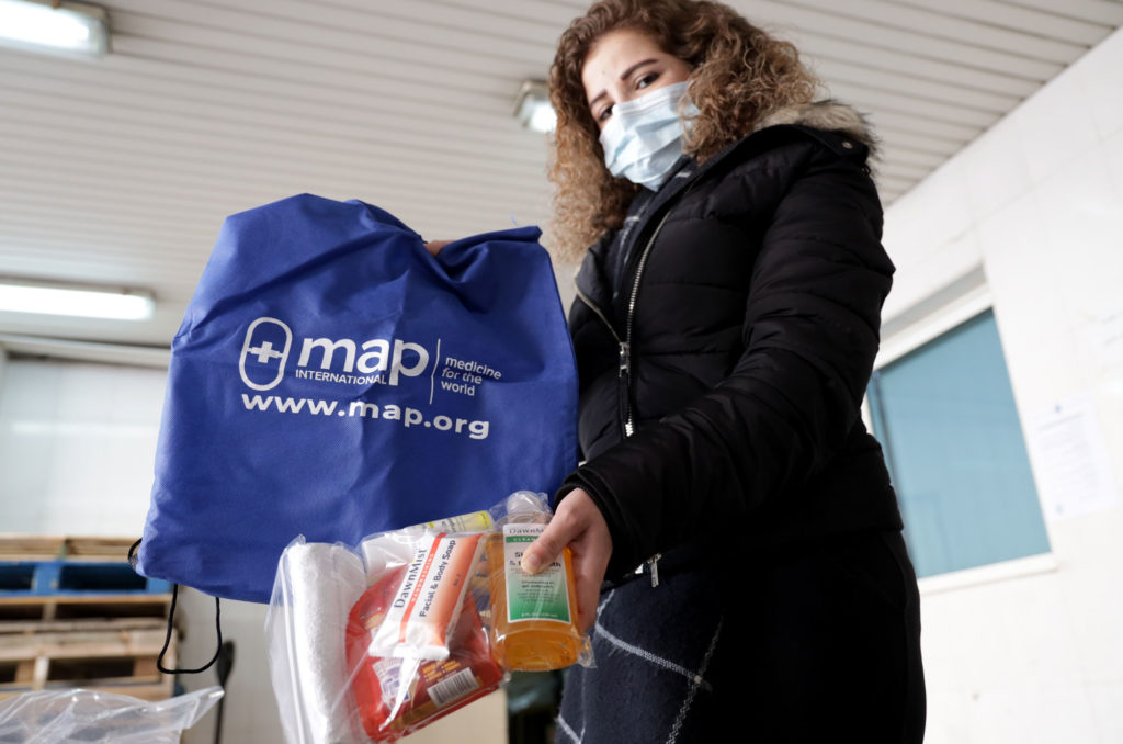 Mirella al-Khalli holds donated hygiene products.