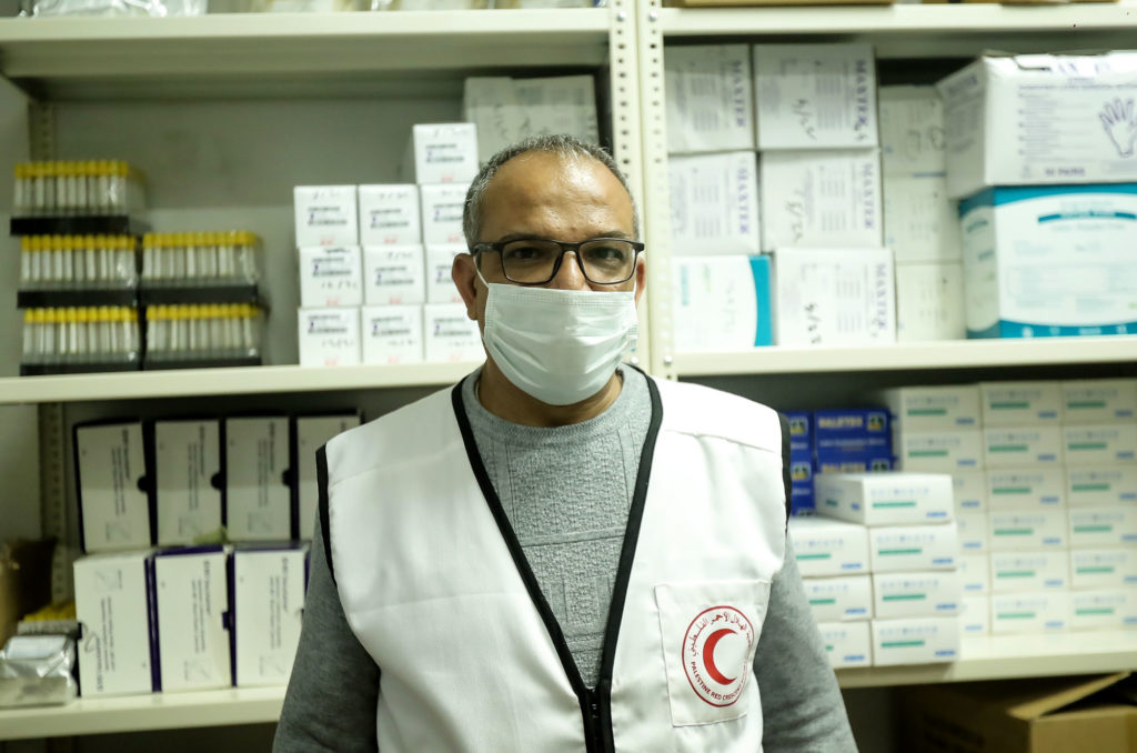 Dr. al-Ahmad in portrait in the pharmacy storeroom.