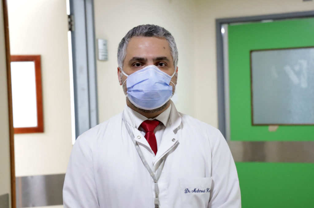 Dr, Hassoun in portrait in hospital hallway.