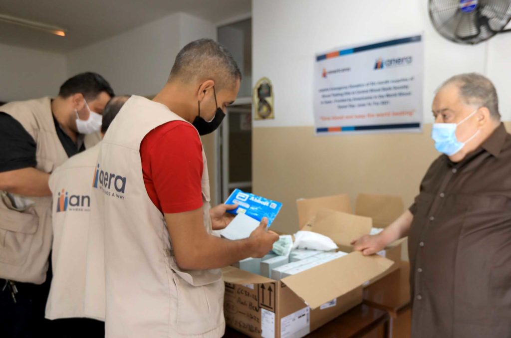 Anera staff delivering blood testing kits to the Gaza blood bank.