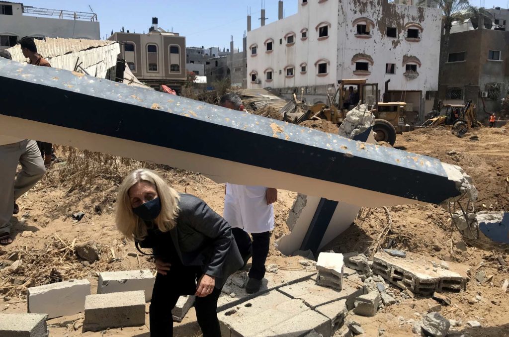 Katherine Wilkins, an Anera board member, walks through rubble in Gaza during a visit in June 2021.