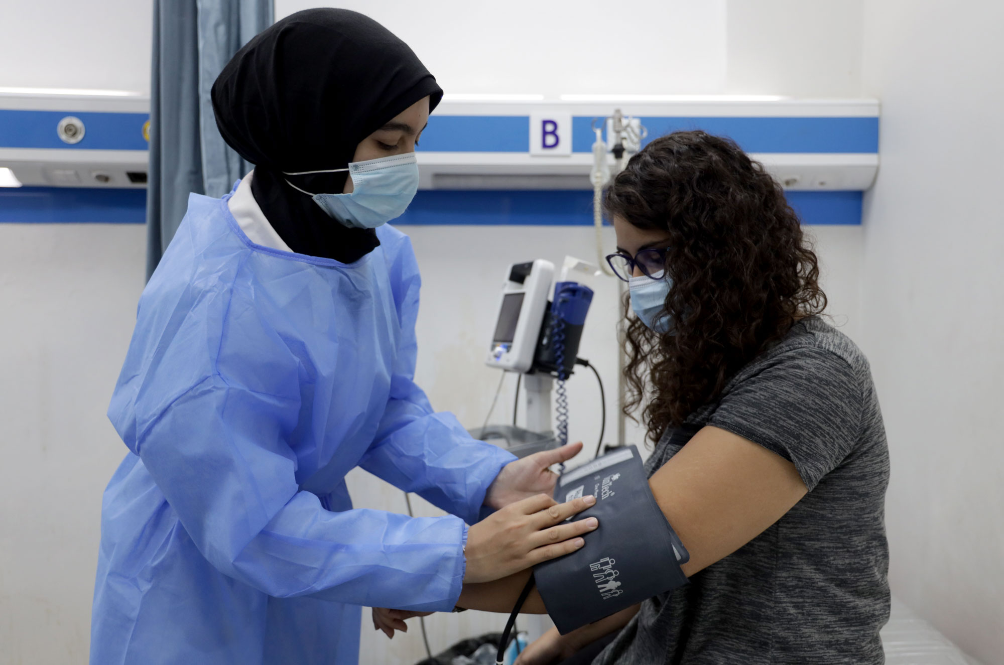 A nurse takes a patient's blood pressure at Haifa Hospital in Lebanon.