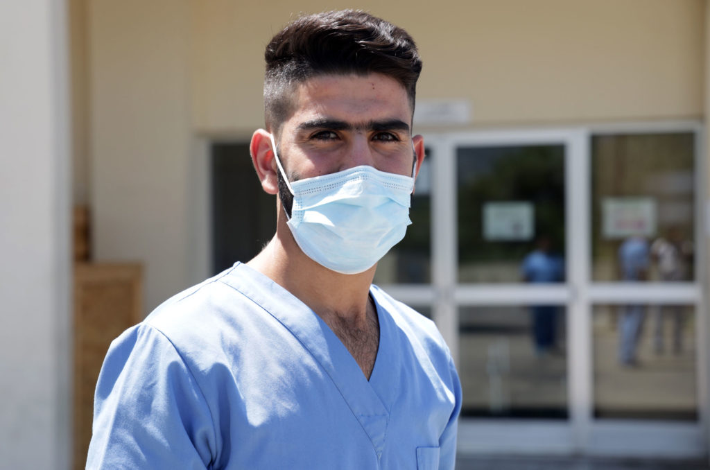 Mohamed Kassab photographed outside the Dahr El Bachek Hospital in his scrubs.