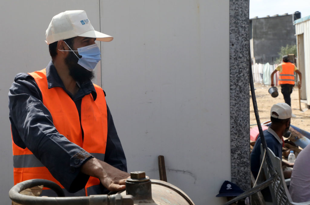 A worker in Mughraqa, Gaza on the construction site of the water well