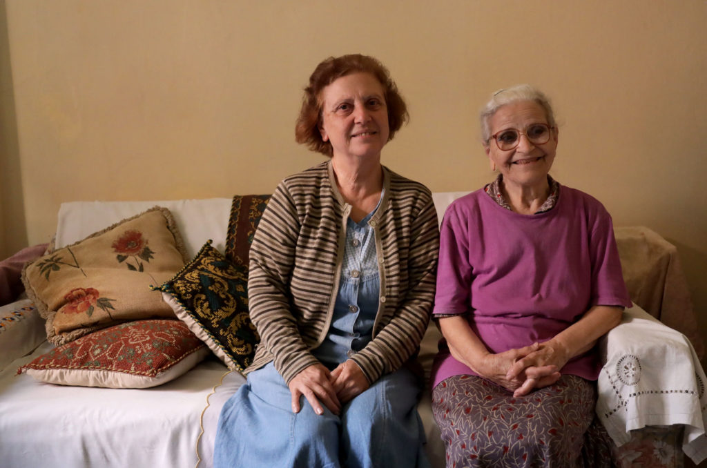 Araksi Khentrajian sits to the right of her daughter on a couch in her Burj Hammoud apartment, Beirut.