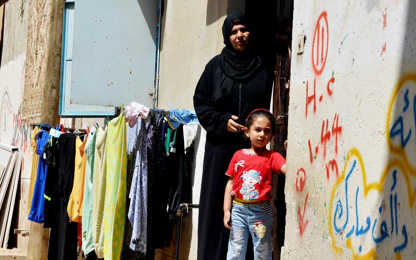 Zayna and grandmother Najah stand outside Najah’s home in the middle of Gaza City.