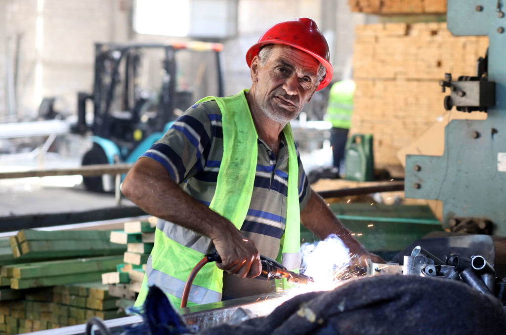 Abdulrahman at work welding in the factory.