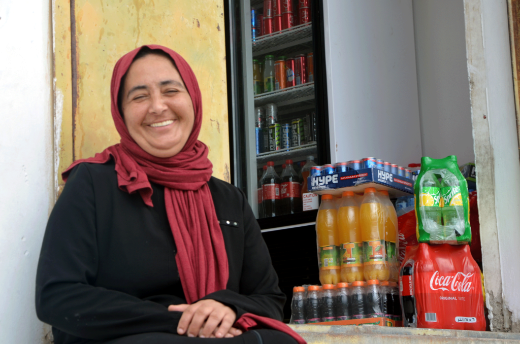 Kawthar smiles in front of her shop