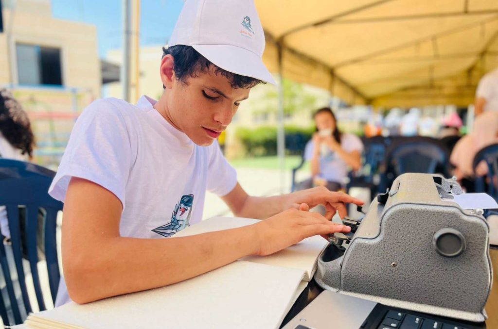 Young man with a visual impairment learns typing skills in the Bekaa Valley
