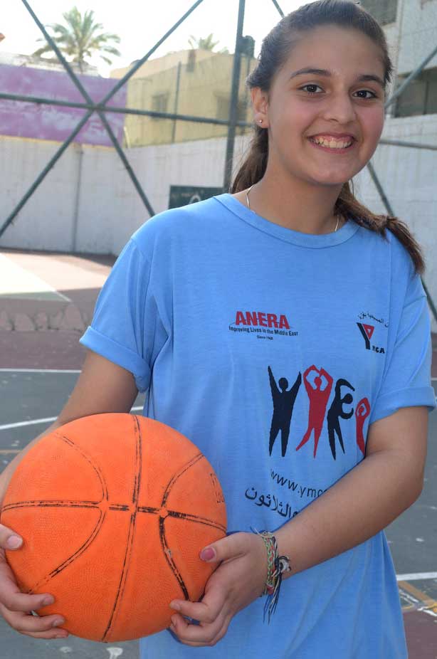 A girl in Gaza on the basketball court during an Anera summer camp at the YMCA.