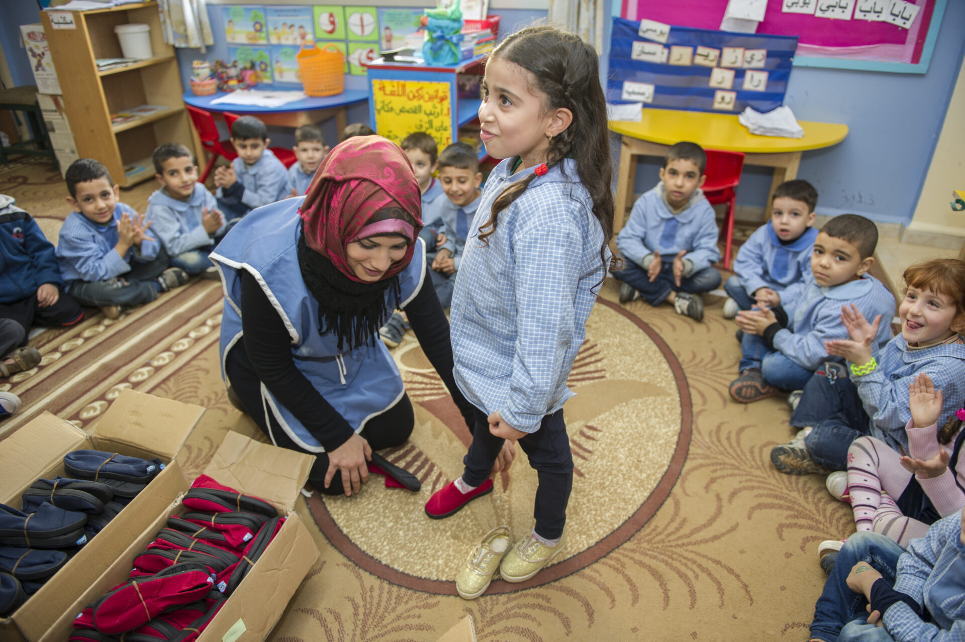 Preschool students receiving TOMS shoes.