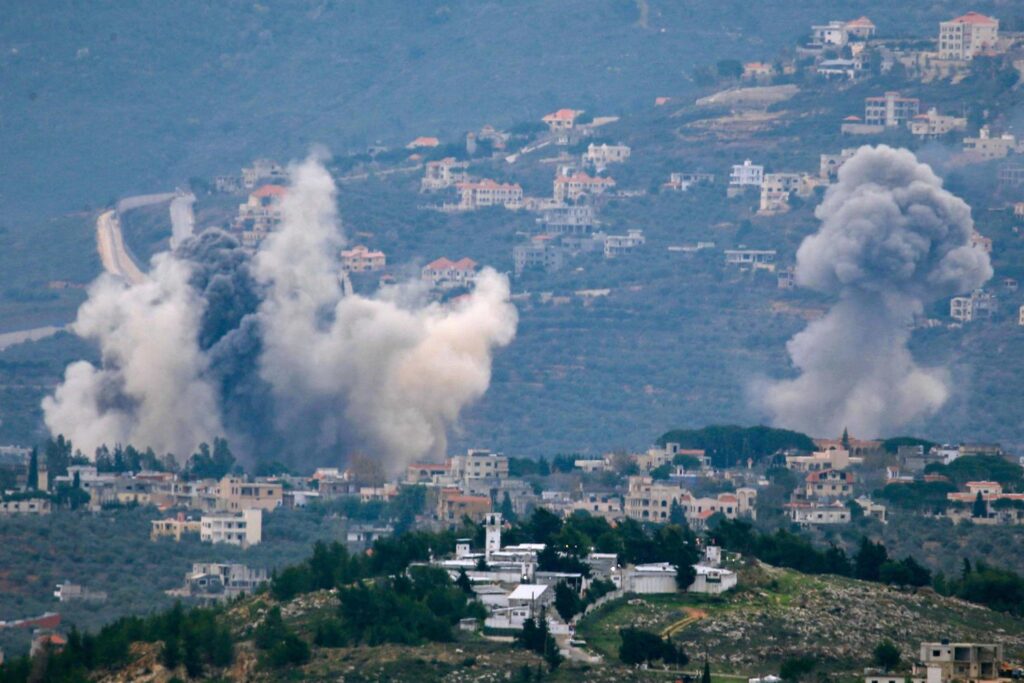 Topshot of smoke rising above a rolling landscape.