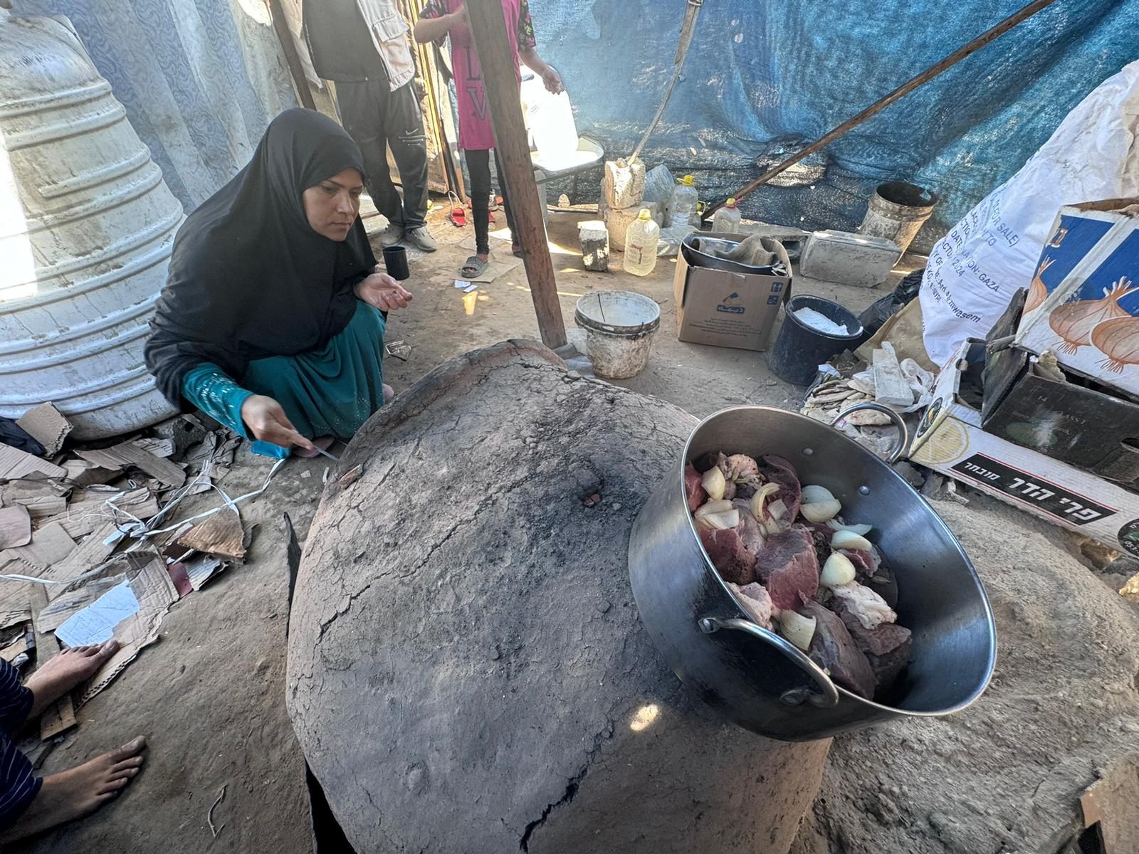 WhatsApp Image 2024-09-18 at 8.06.01 PM Um Mohammad preparing the meat for her family.