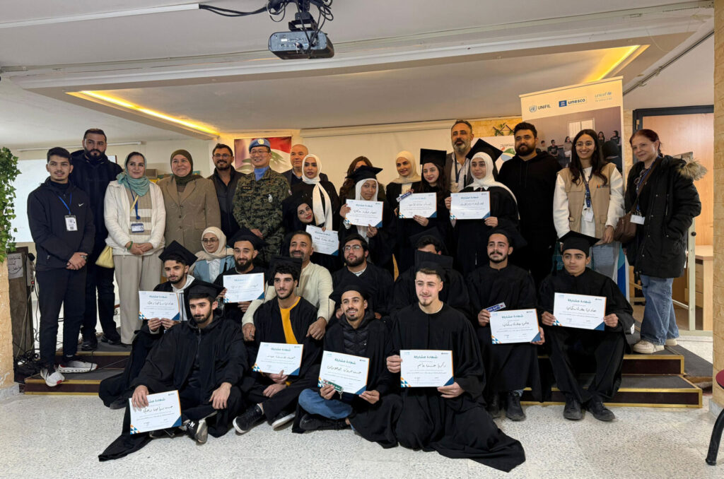 Anera's beekeeping course graduates hold their diplomas.