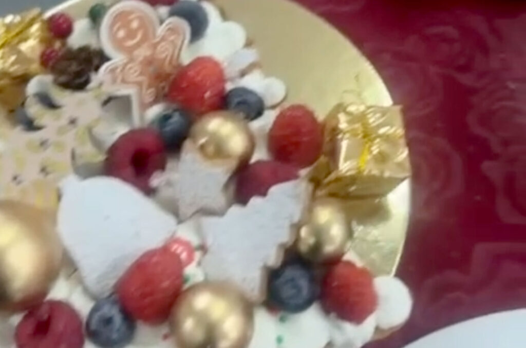 The buffet table of dishes and desserts is shown, including pizzas, cakes and cookies.