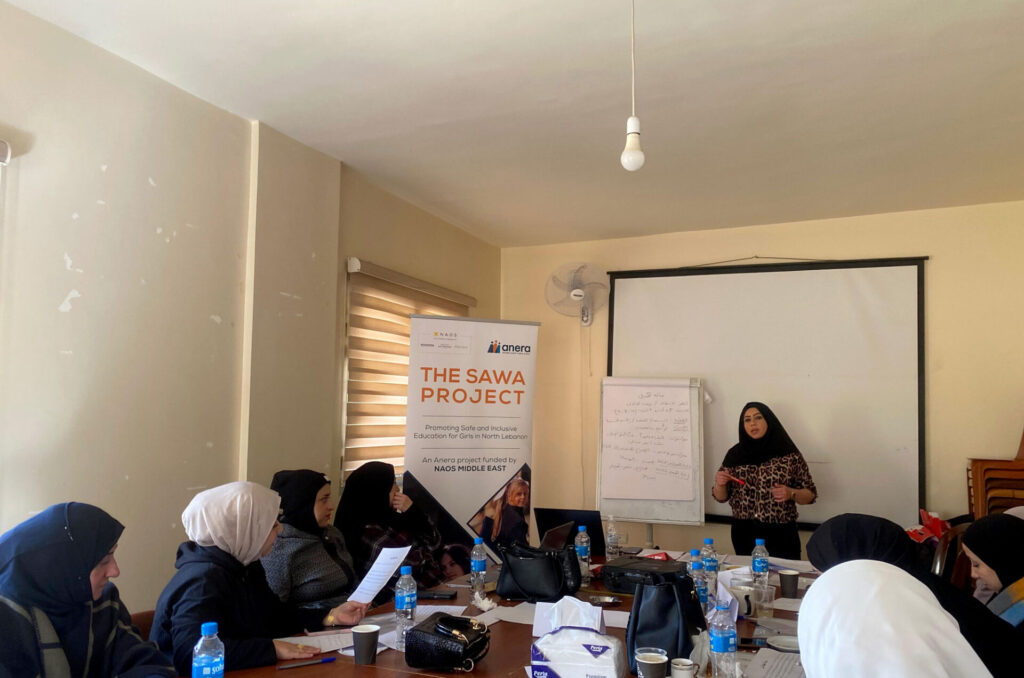 Teachers sitting around a table learn about child safety principles.