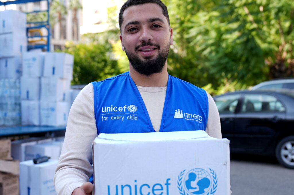 lebanon,winterization-response,dec-2025 A UNICEF staff member holds a box of winter aid items