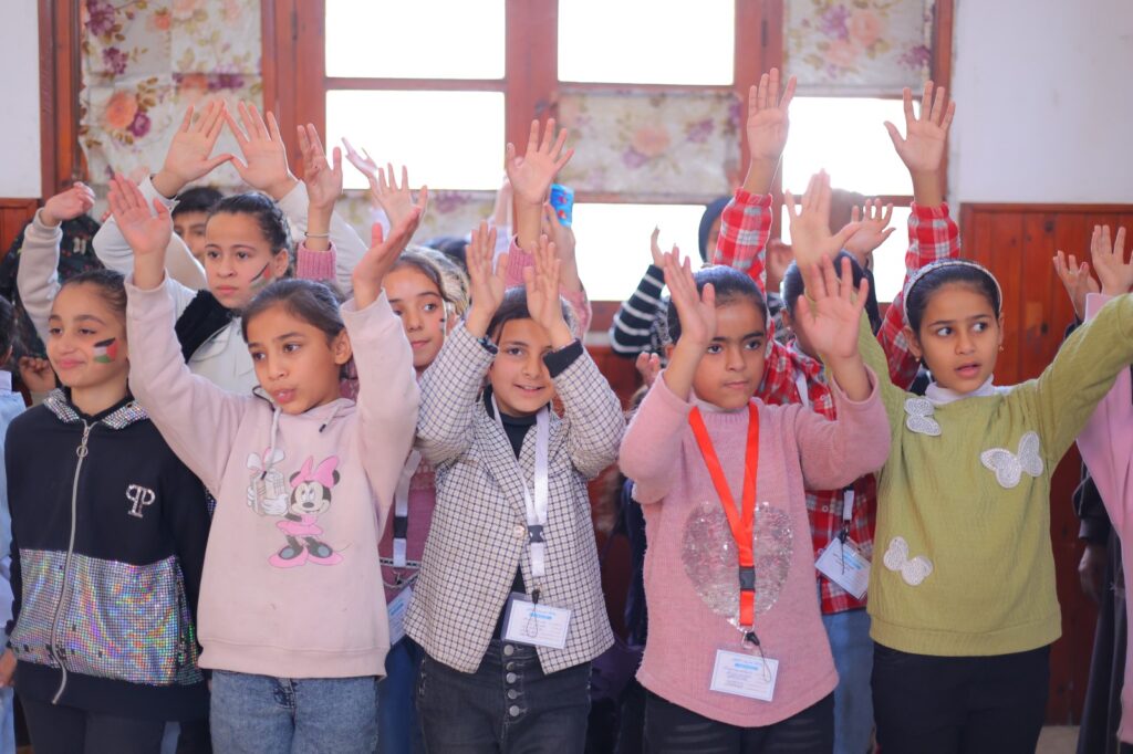 young Gazan schoolchildren singing and clapping their hands