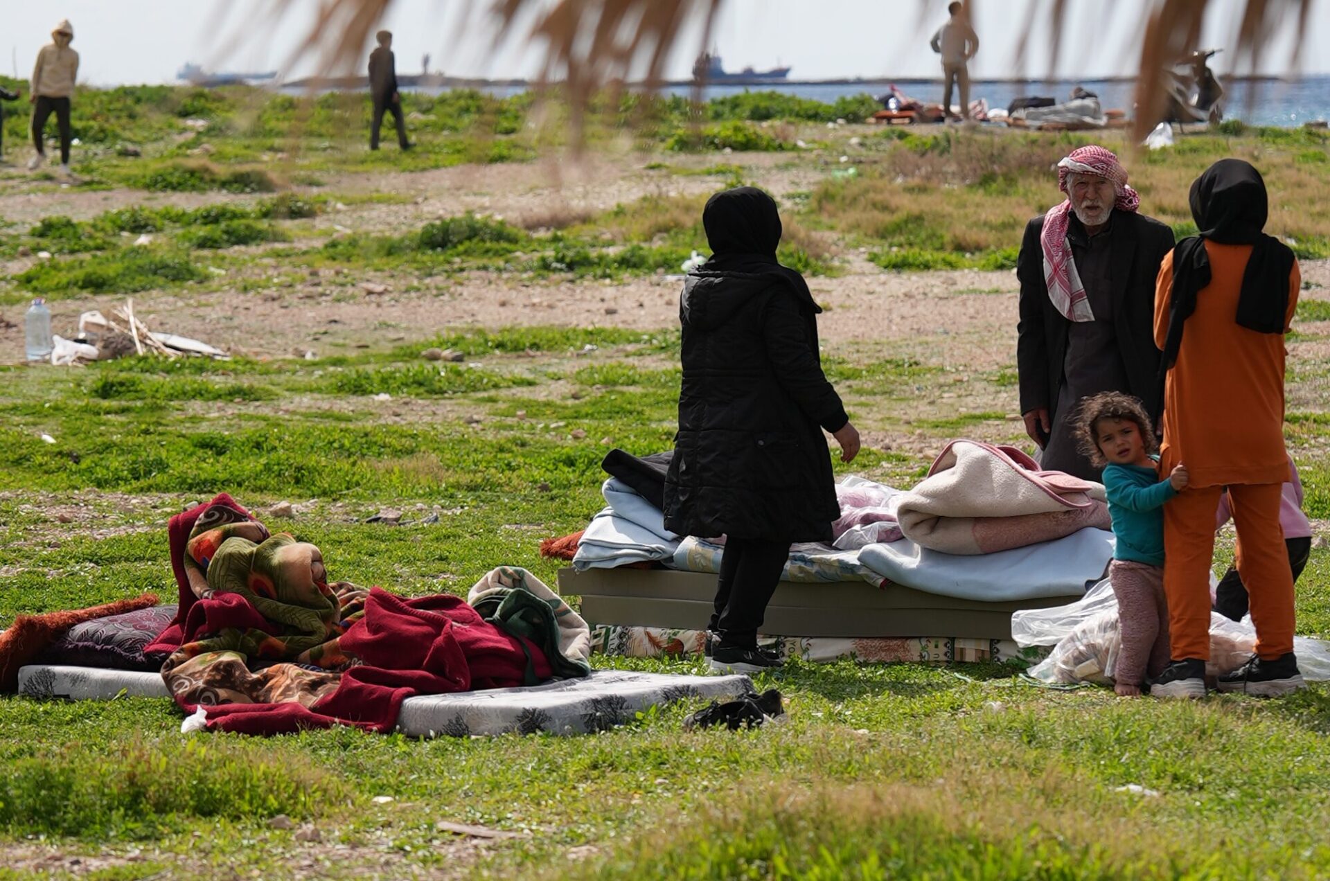 family preparing to sleep outside