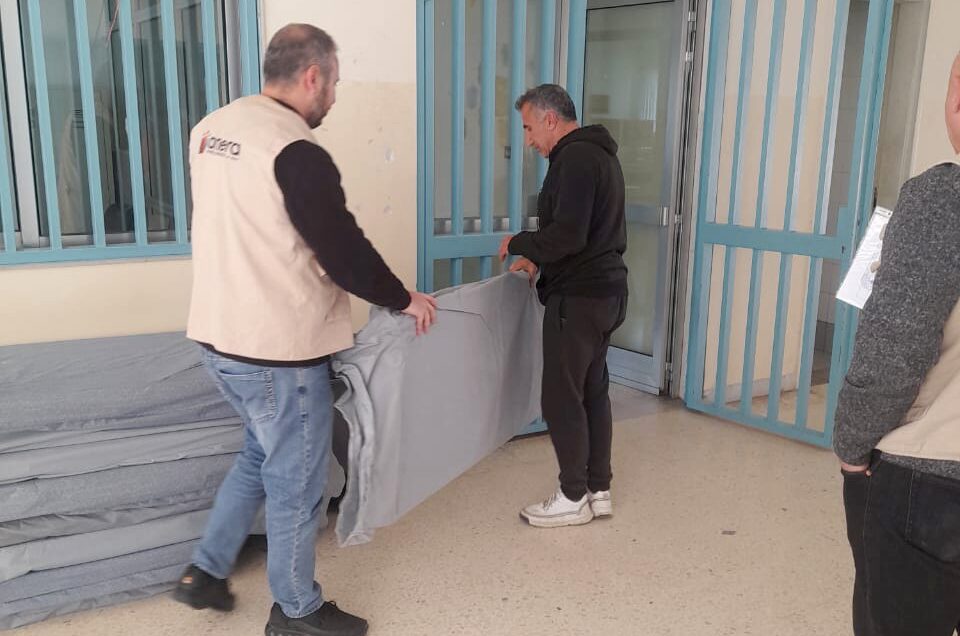 two men delivering mattresses