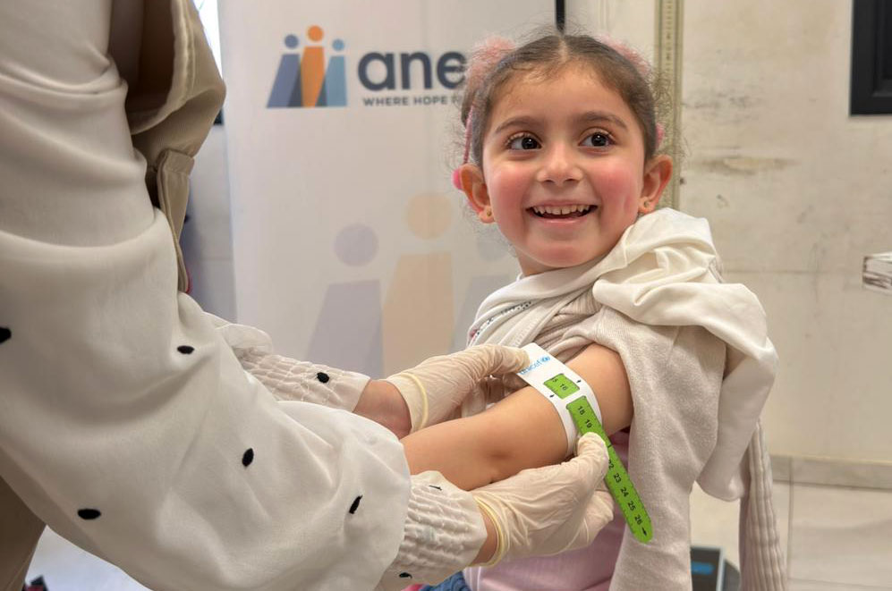 Measuring the circumference of a student's arm at one of our temporary learning spaces in Gaza.