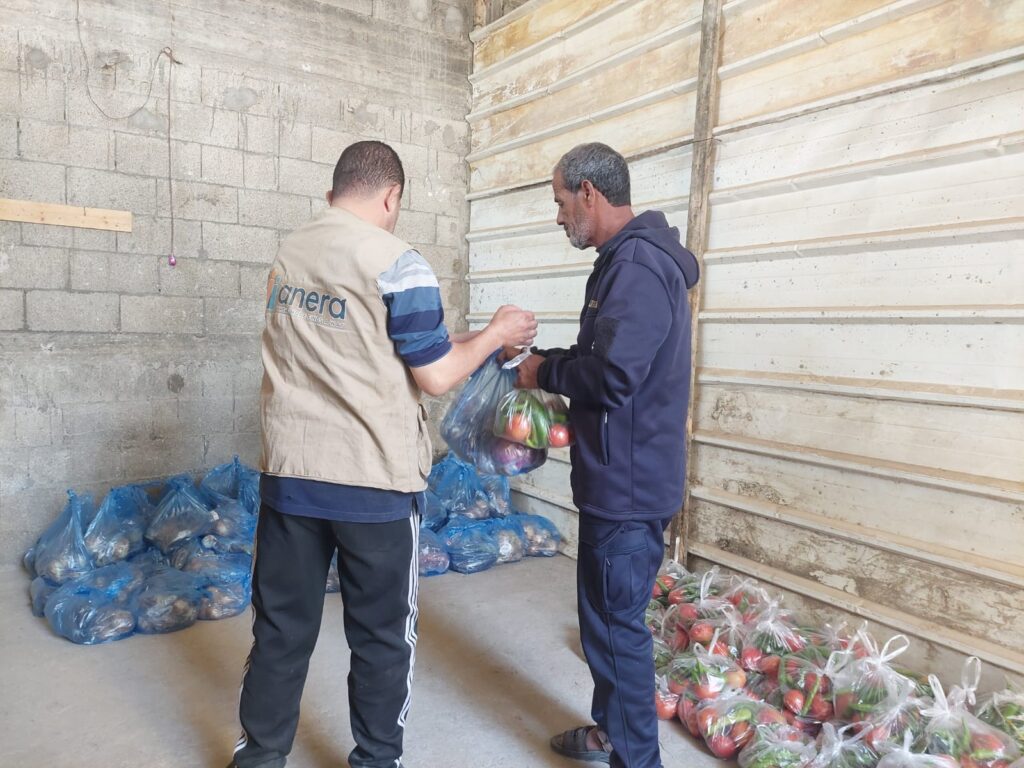 A father in Gaza City picks up a fresh produce for his family.