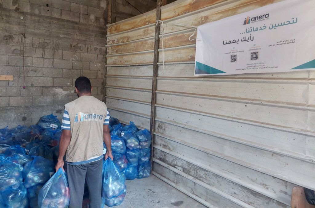 An Anera worker gathers fresh produce parcels to hand to registered recipients.