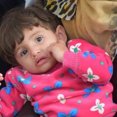 Mahmoud, a toddler looks at the camera