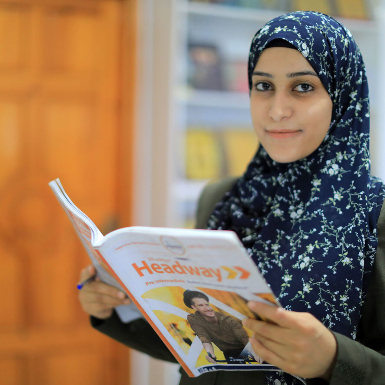 Teacher reading from a book at the new Unlimited Friends Association building in Gaza
