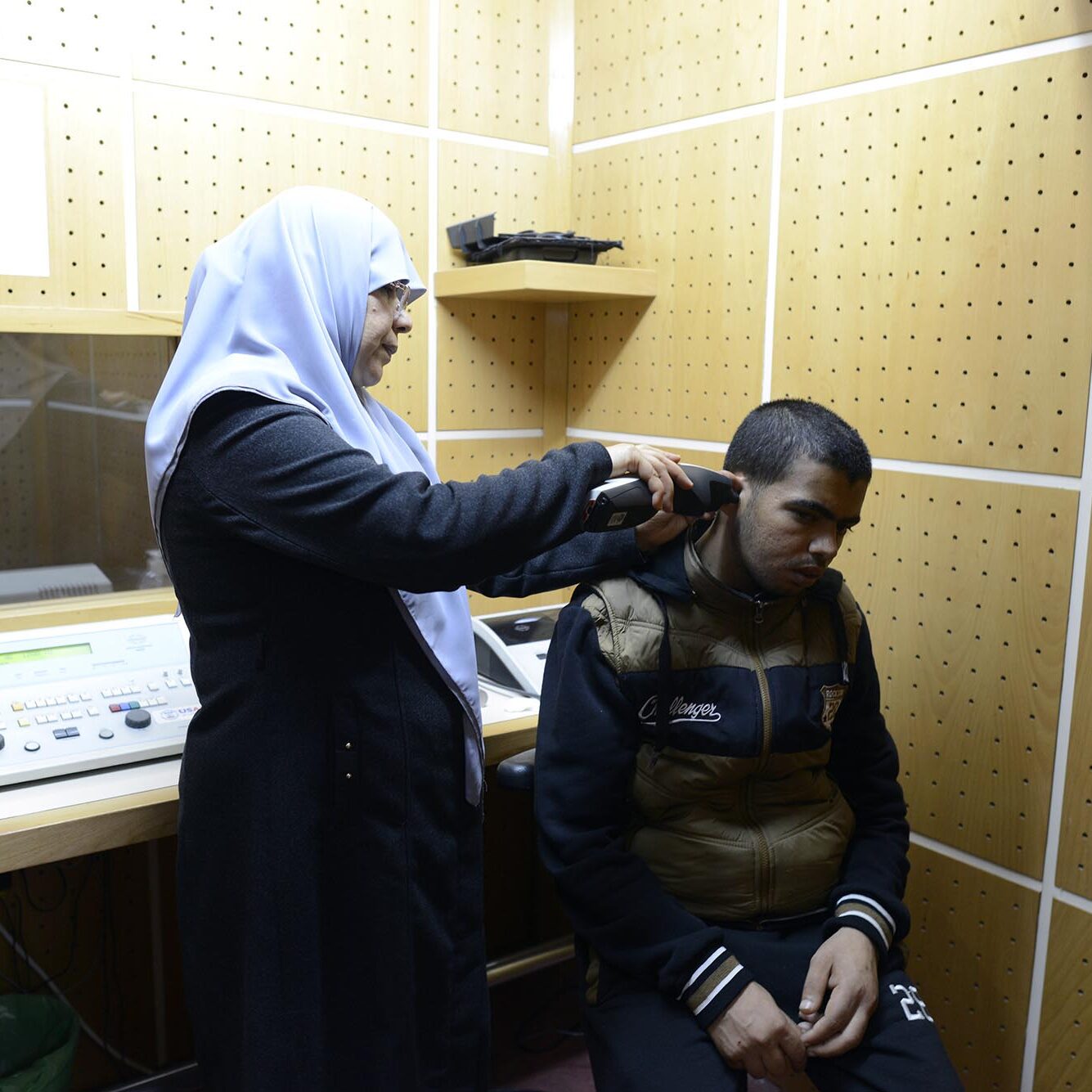 Mahasen performing and examination in the audiology department.