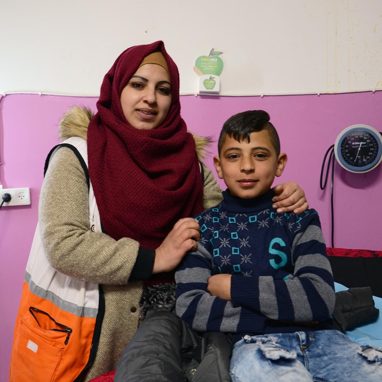11-year-old Riad Al-Sharha and his mother at the Dura Charitable Medical Center