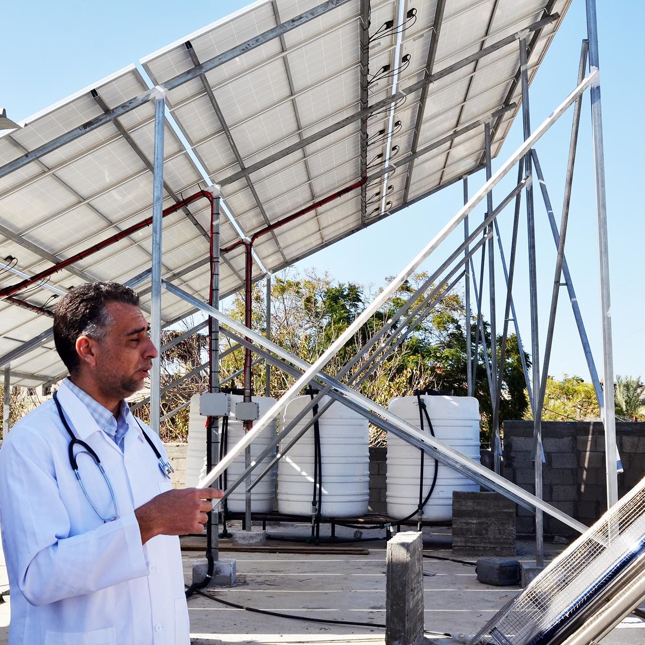 Dr. Humeida shows us the solar panels up on the roof of the clinic in Beit Lahia.