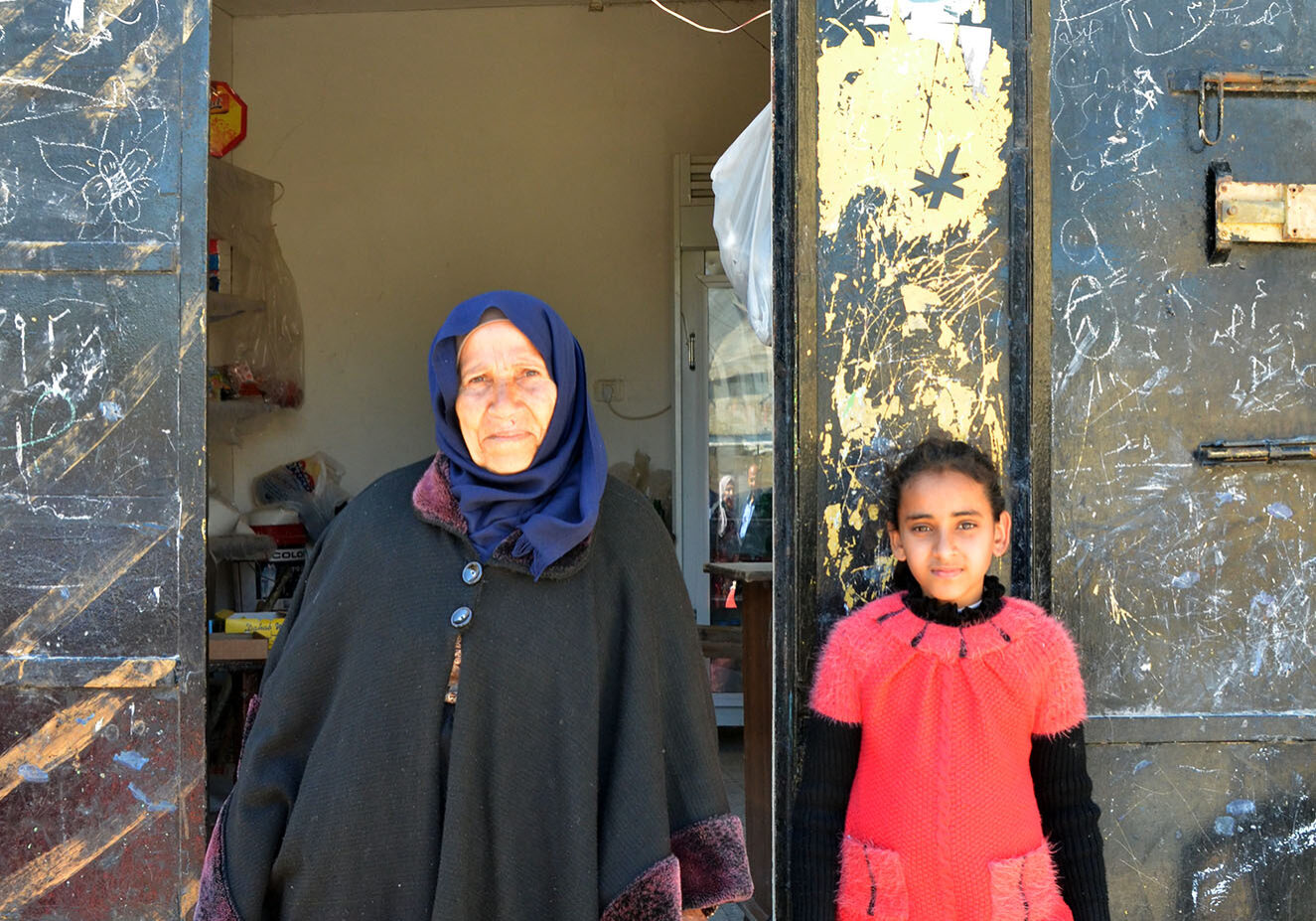 Haja Suhaila and her granddaughter Hala infront of their shop.