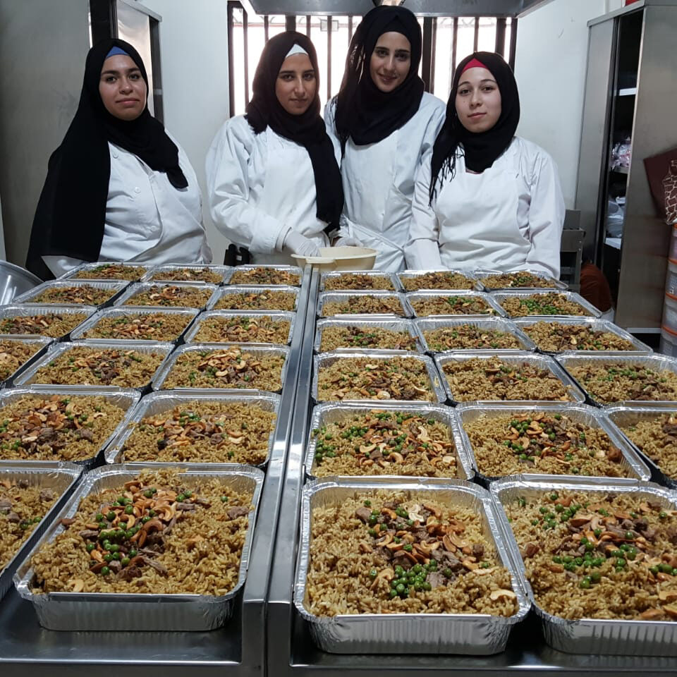 Our cooking and vocational course students preparing meals for vulnerable families in Lebanon.