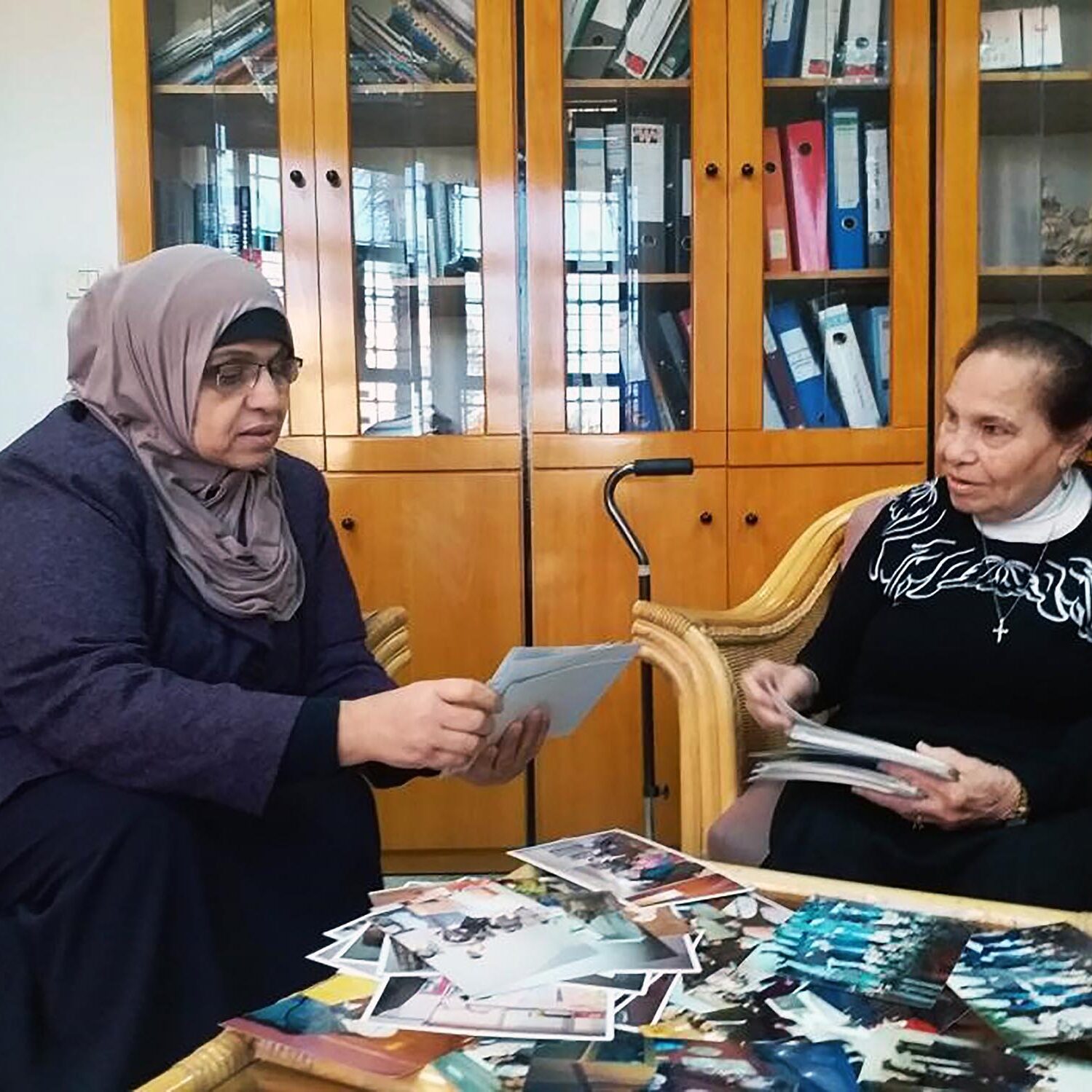 Sabah and Hilda look at old pictures recalling the history of the Anera partnership.