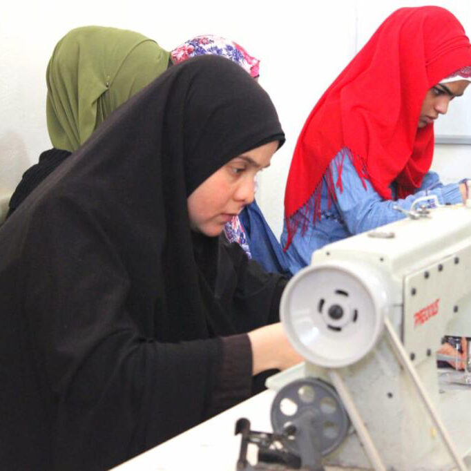 Sewing course students make blankets and clothing for refugee families.