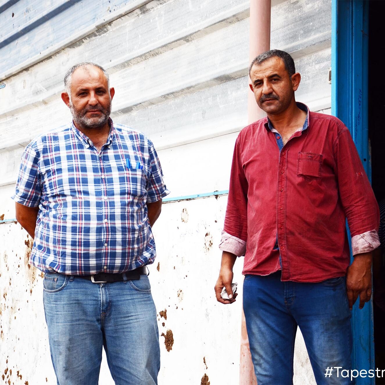 Thabet (left): "We work until we finish the day's produce of olives, even if it means working around the clock. Today we opened the press at five in the morning, and we'll see how things go. I expect it will be another late night."

Adel (right): "Olive oil is green gold and we need the continued support of local and international organizations to preserve it." - Thabet and Adel, olive farmers (Idhna, West Bank) [Photo: Brothers Thabet and Adel, standing in front of their olive oil processing facility in Idhna]