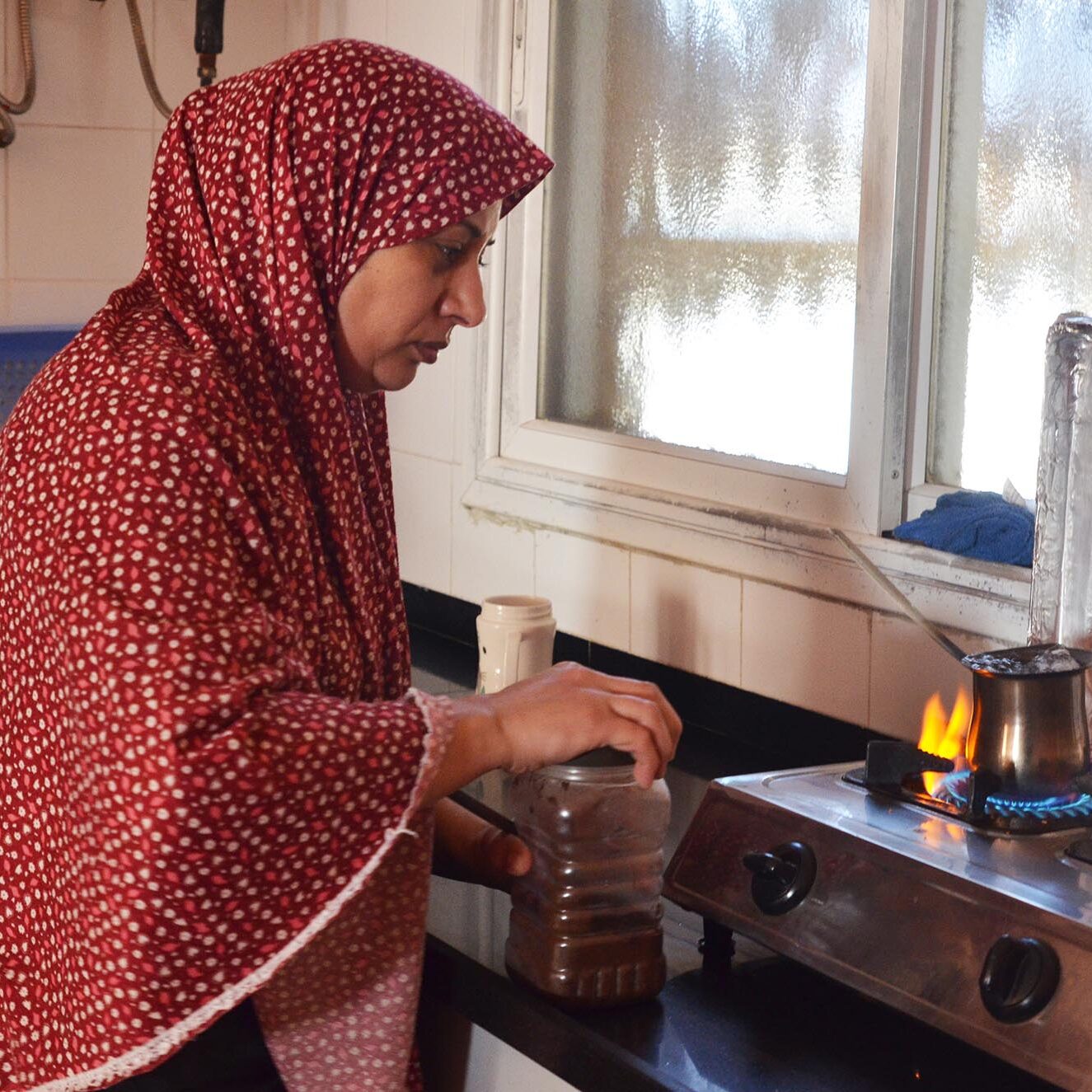 Zahira, a resident of Beit Hanoun in northern Gaza, boiling water in her coffee pot.
