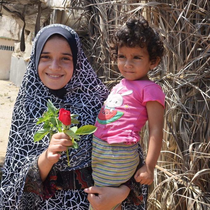 Sabah’s daughter Heba helps out in the greenhouse during the summer break before she begins sixth grade.