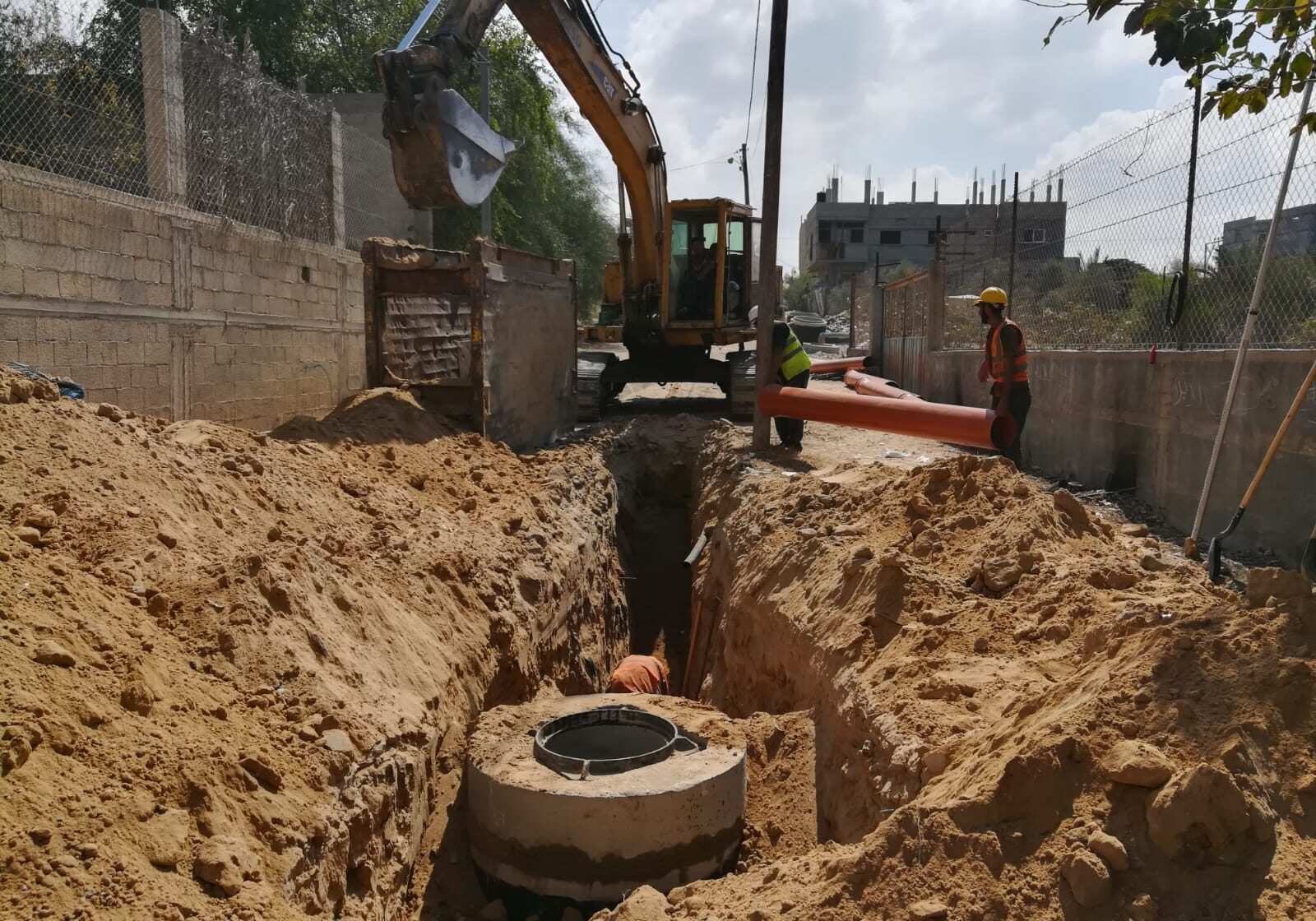 Sewage pipes being fitted into place.